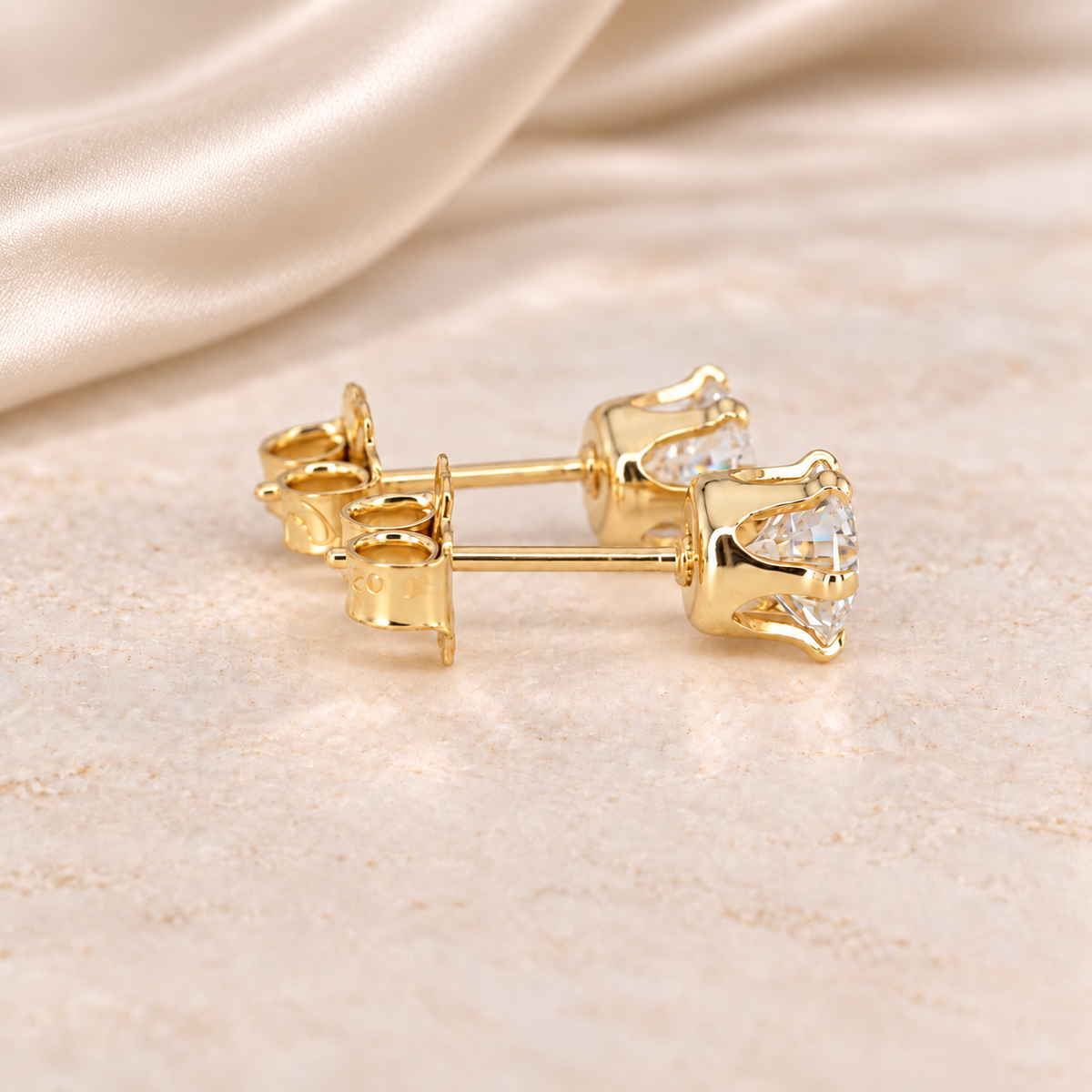 Alternate side view of 1 CTW moissanite stud earrings showing open six-prong 14/20 gold-filled basket settings.