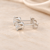 Alternate side view of 1 CTW moissanite stud earrings showing open six-prong S925 sterling silver basket settings.