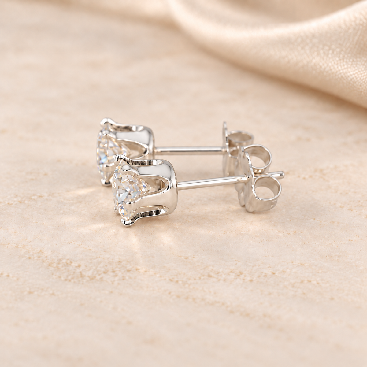Alternate side view of 1 CTW moissanite stud earrings showing open six-prong S925 sterling silver basket settings.