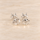 Back view of 1 CTW moissanite stud earrings showing sterling silver posts, six-prong settings and butterfly backs.