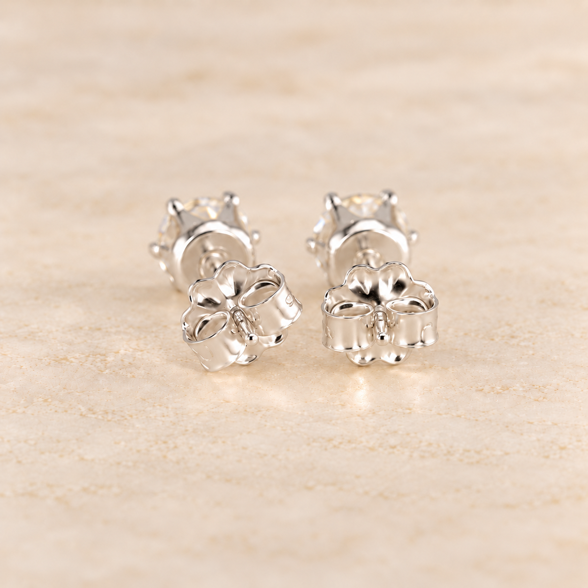 Back view of 1 CTW moissanite stud earrings showing sterling silver posts, six-prong settings and butterfly backs.