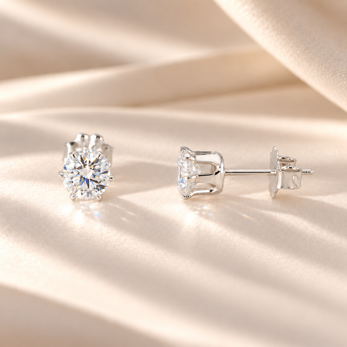Front and side views of 1 CTW moissanite stud earrings showing six-prong S925 sterling silver basket settings and posts.