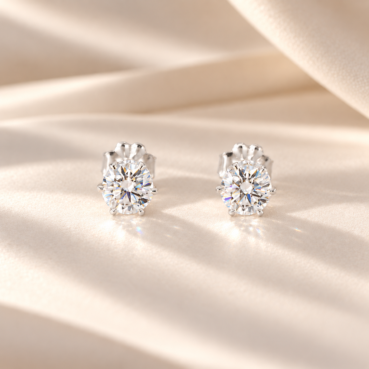 Front view of two 0.50 carat round moissanite stud earrings in six-prong S925 sterling silver settings, 1 CTW.