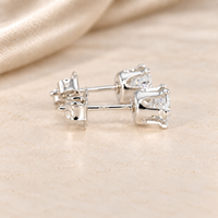 Side view of 1 CTW round moissanite stud earrings showing six-prong sterling silver baskets, posts and butterfly backs.