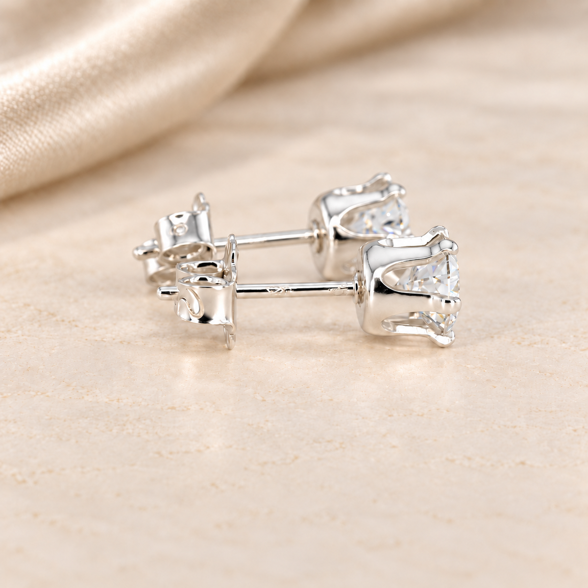 Side view of 1 CTW round moissanite stud earrings showing six-prong sterling silver baskets, posts and butterfly backs.
