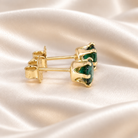 Alternate side view of 5mm round lab emerald stud earrings showing the open six-prong 14/20 gold-filled settings and backs.