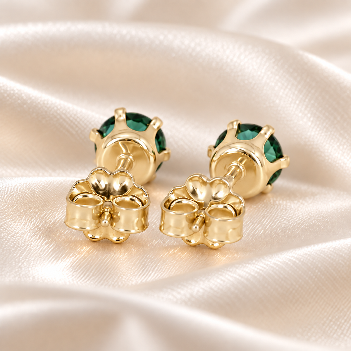 Back view of 5mm lab emerald stud earrings showing six-prong gold-filled settings, posts and butterfly backs.