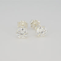 360-degree view of 1 CTW round moissanite stud earrings in six-prong S925 sterling silver settings on a white background.