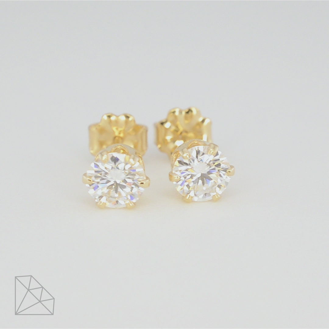 360-degree rotating view of two 0.5 carat round moissanite stud earrings in 14k gold-filled settings, showing front and side angles.