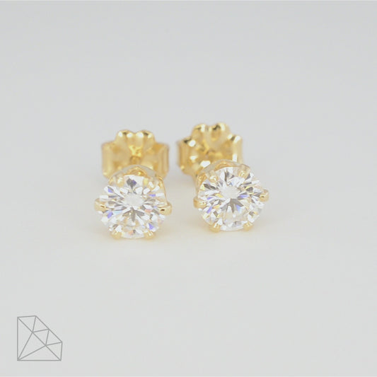360-degree rotating view of two 0.5 carat round moissanite stud earrings in 14k gold-filled settings, showing front and side angles.