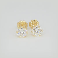 360-degree view of 1 CTW round moissanite stud earrings in six-prong 14/20 gold-filled settings on a white background.