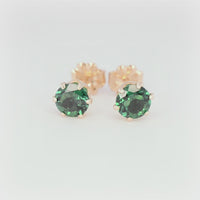 360-degree view of 5mm round Zambian-color lab emerald stud earrings in six-prong 14/20 gold-filled settings on a white background.